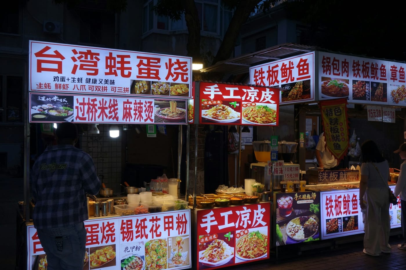 A traveler eating noodles at a street food stall in China