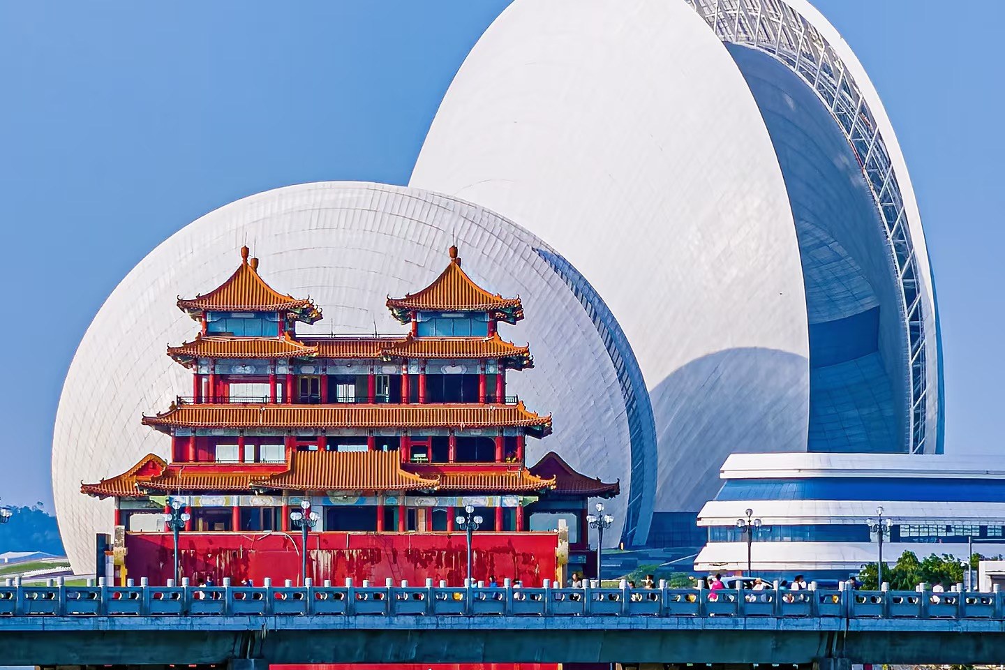 Zhuhai Opera House Sun Moon Shells beside a traditional pavilion on the Yeli Island waterfront
